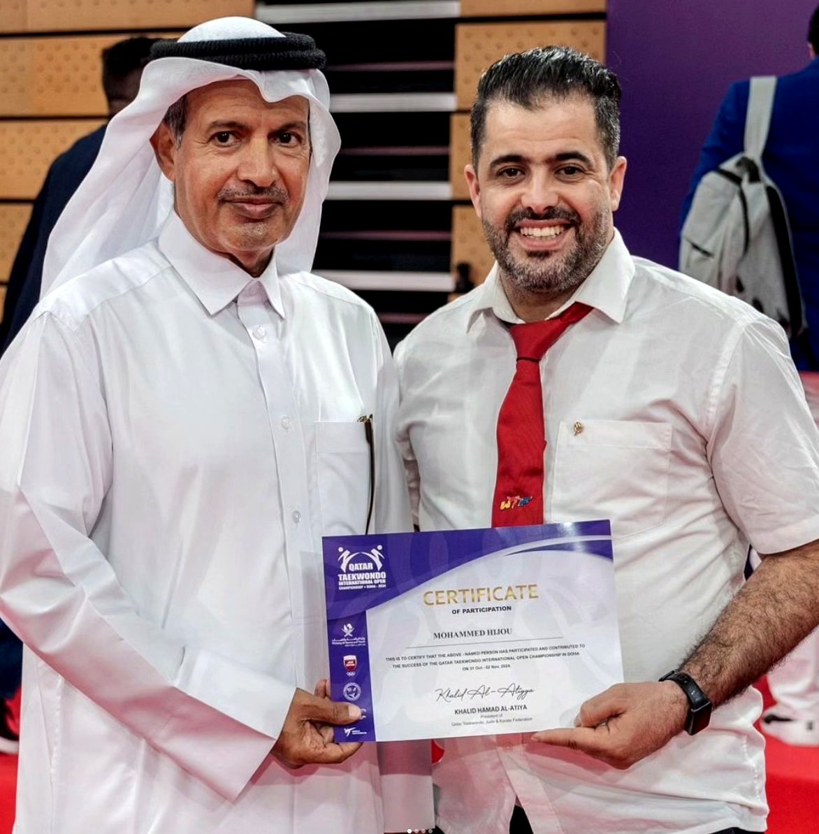 Coach Mohammed Hijou receiving certificate from the President of Qatar Taekwondo, Judo & Karate Federation